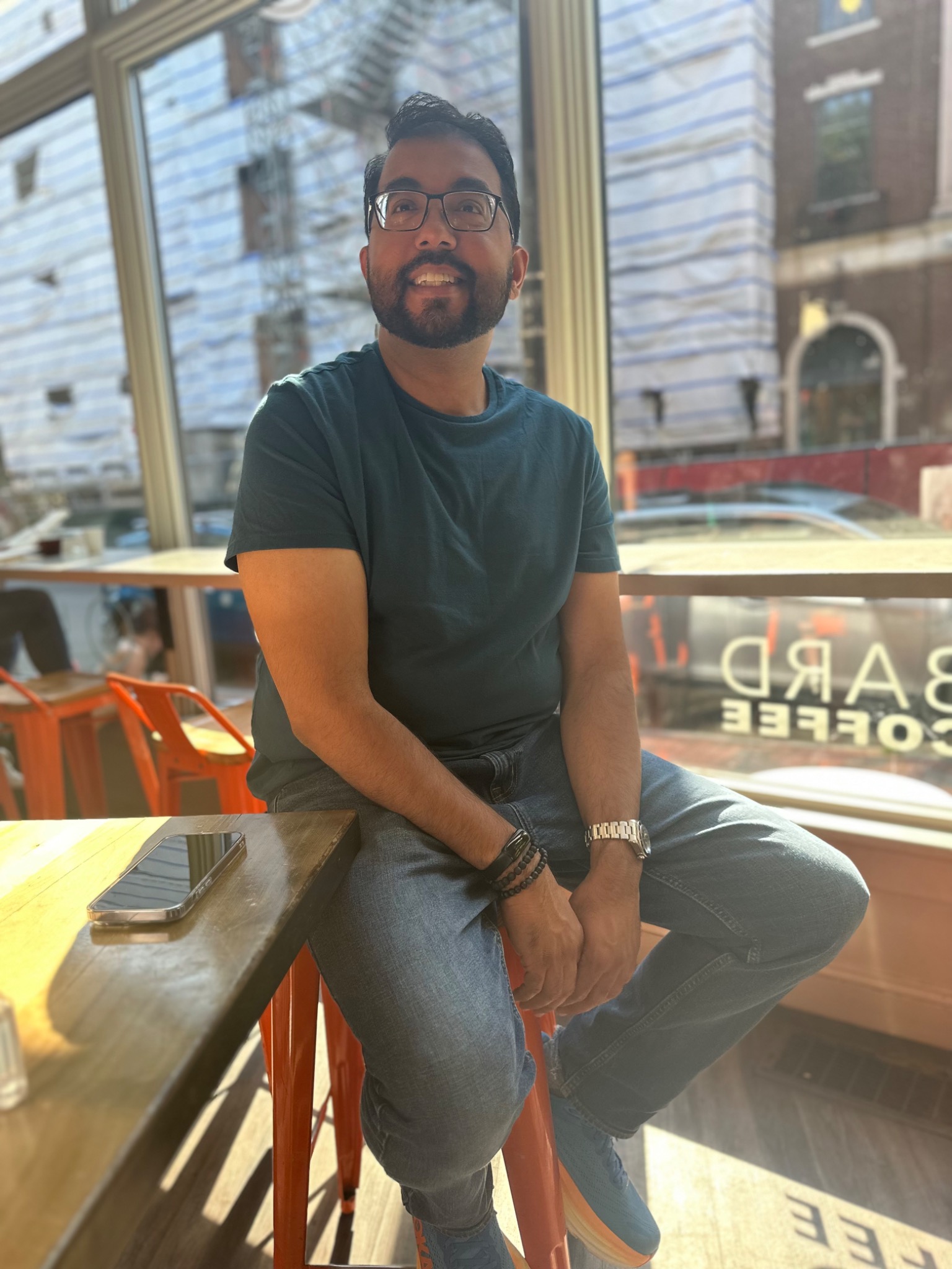 Amer Nazar smiling in a café